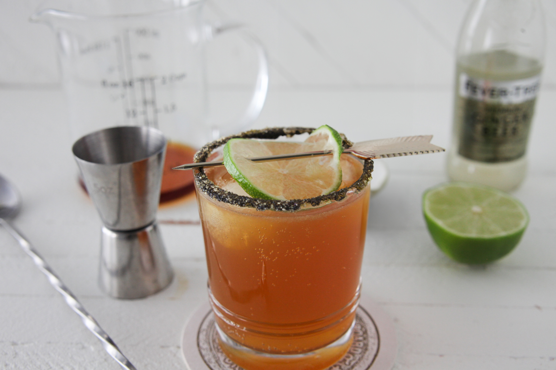 Stormy Brees cocktail in a glass, garnished with lime slice