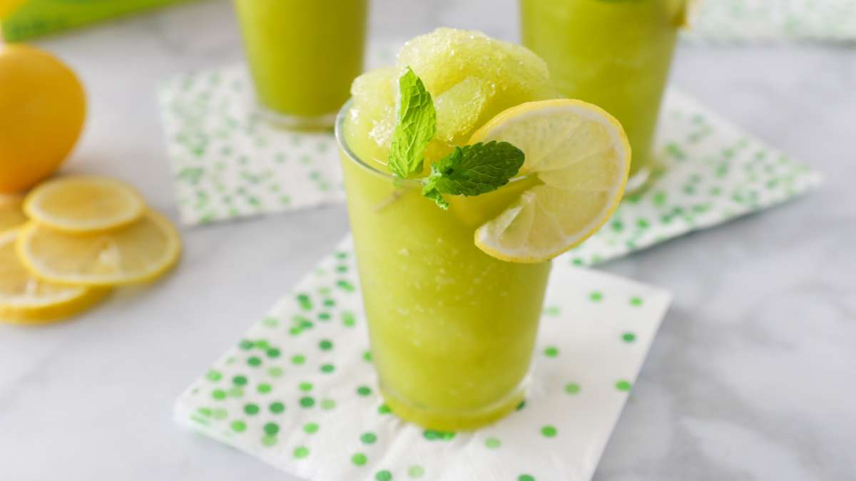 2 glasses of frozen Lemonita with mint, garnished with lemon and fresh mint, made with Luzianne Iced Green Tea