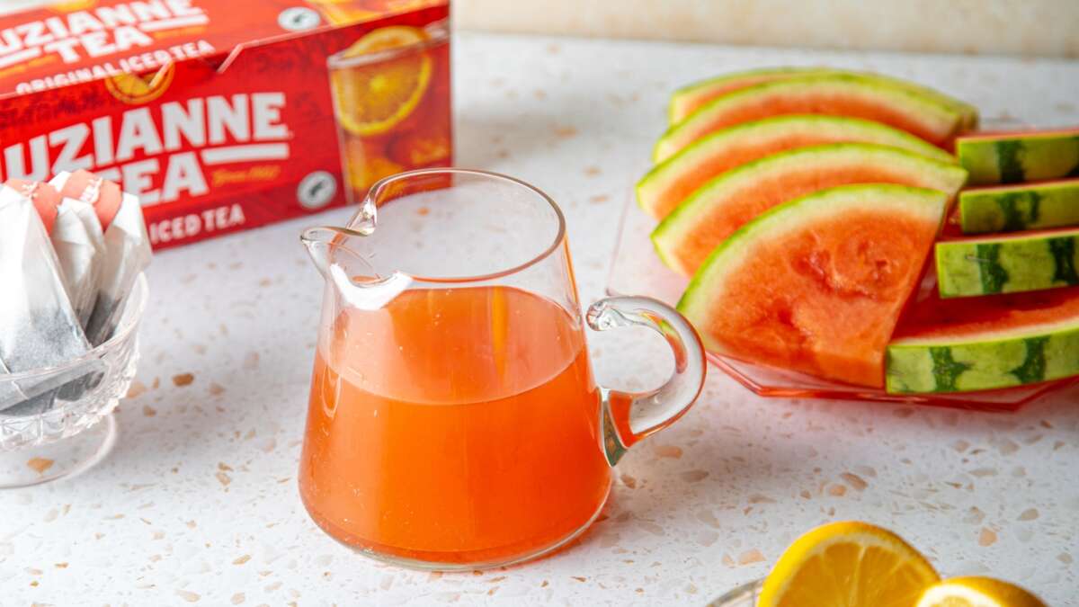 Watermelon Syrup in a serving pitcher. Use to make Luzianne Tea drinks and cocktails.
