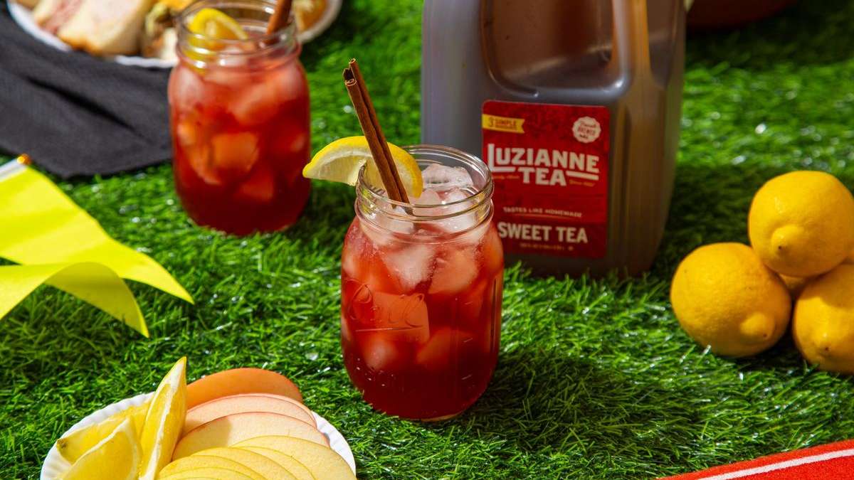 fall orchard tea punch with a luzianne sweet tea gallon size in background