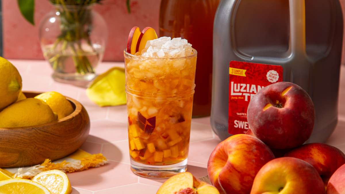 Louisiana Peach Tea Crush cocktail in tall glass with crushed ice