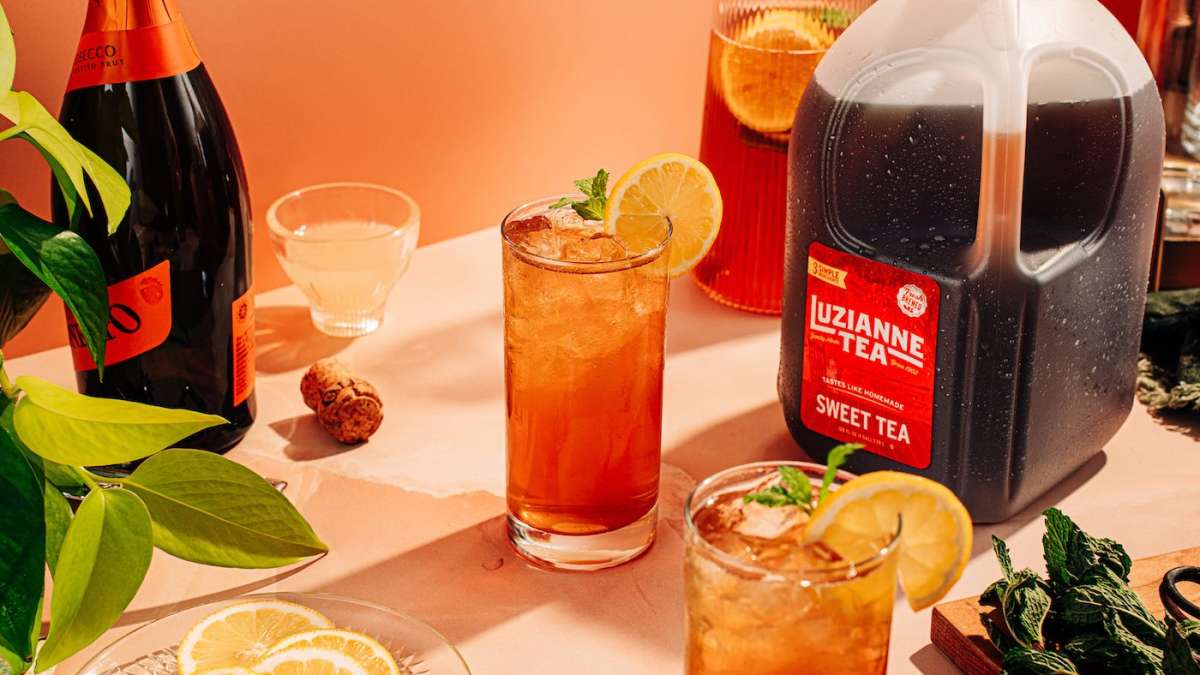 prosecco sweet tea spritz in glasses with gallon jug sweet tea